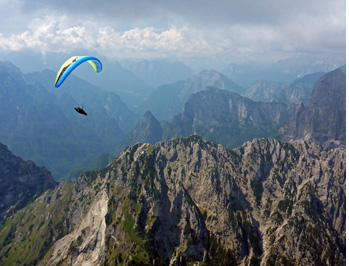 Cross country paragliding along the first ranges of the Dolomites in Piave Valley in Italian Alps between Belluno and Feltre.