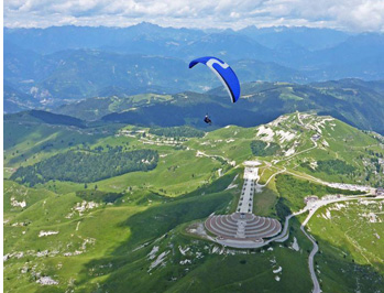 Paragliding at Bassano. The grassy high plateau of Cima Grappa of the Bassano range.