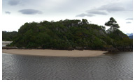 Punta Cuchillo - Rocky outcrop with a mouth of a stream along Playa San Quintin, Golfo de Penas, Aisen, Patagonia, Chile