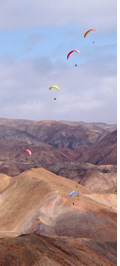 Paragliding above mountainous desert plateau of Altos de Chipana, Iquique, Atacama Desert, Chile 