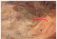 Altos de Chipana - Paragliding above mountainous desert plateau of Altos de Chipana, Iquique, Atacama Desert, Chile - Pilot: Ned Israelsen, USA - Fly Atacama 2008 participant