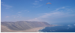 Starting an XC paragliding flight from San Marcos toward Iquique, Atacama Desert, Chile