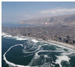 Paragliding way into the ocean from the coast of the town of Iquique, Atacama Desert, Chile