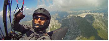 At cloudbase along Krn :: Jarek Wieczorek at cloudbase flying the mighty Krn range, Soca Valley, Julian Alps, Slovenia